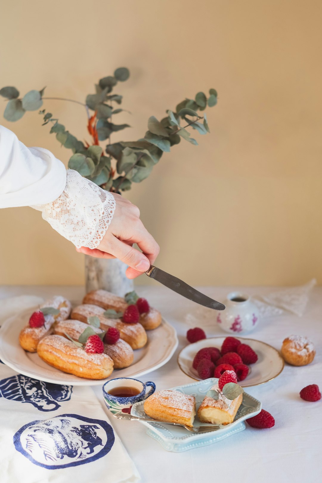 person slicing meat on white ceramic plate