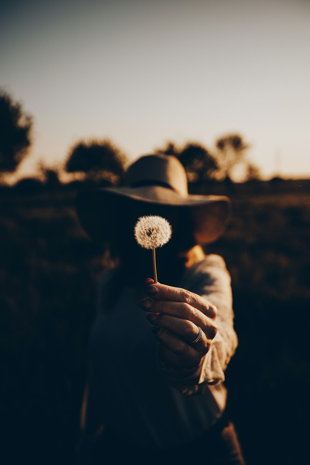 person holding a white lollipop