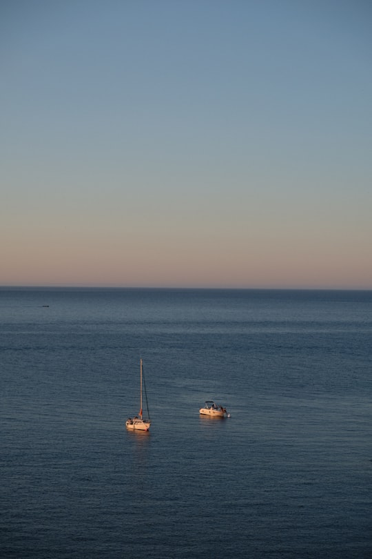 white and brown boat on sea during daytime in Collioure France