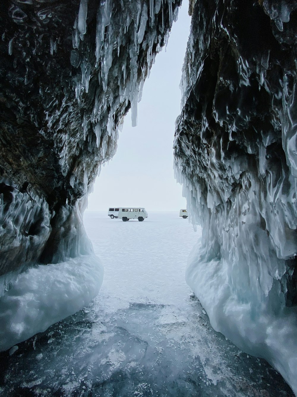 white car on snow covered road