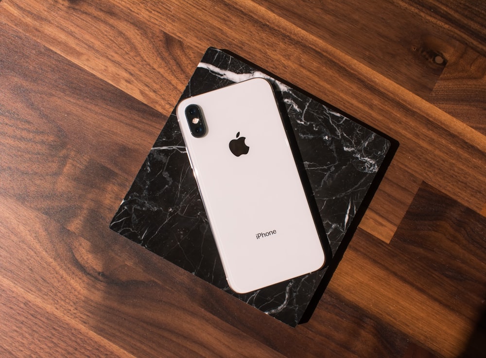 silver ipad on brown wooden table