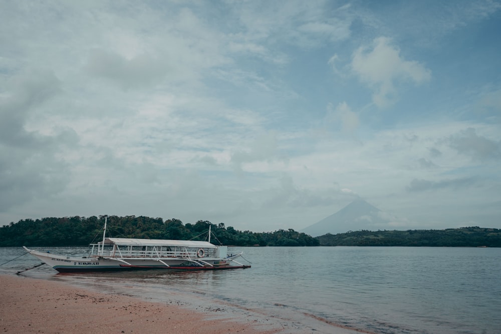 white boat on sea during daytime