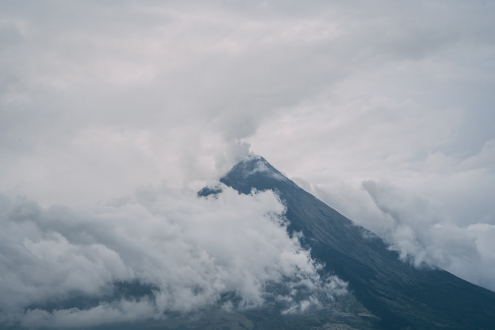 white clouds over black mountain