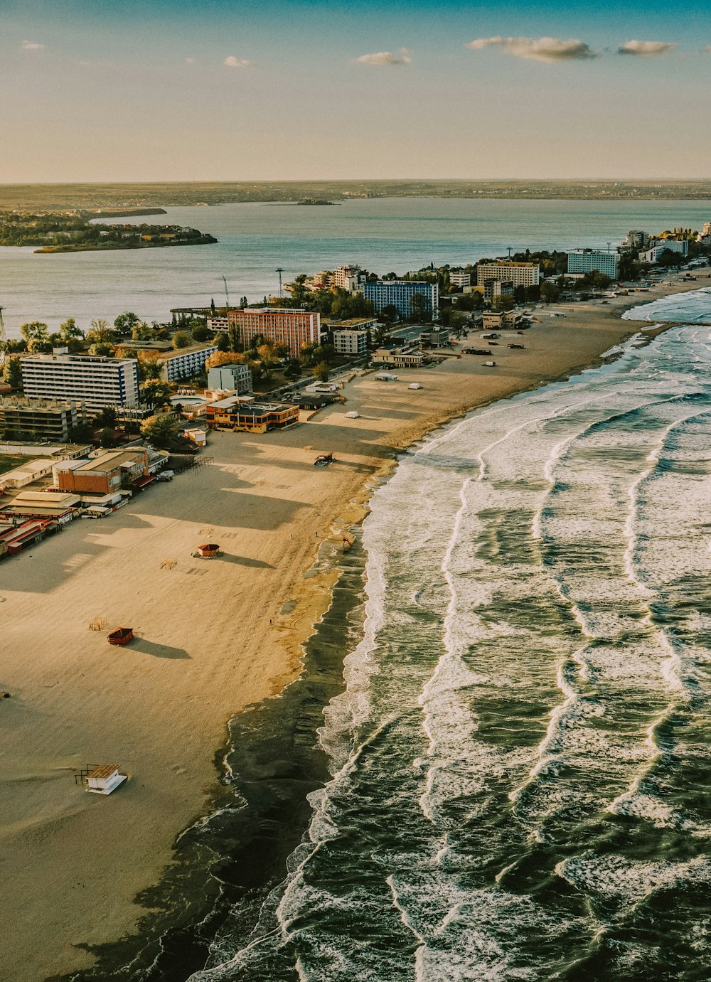 aerial view of city buildings near sea during daytime