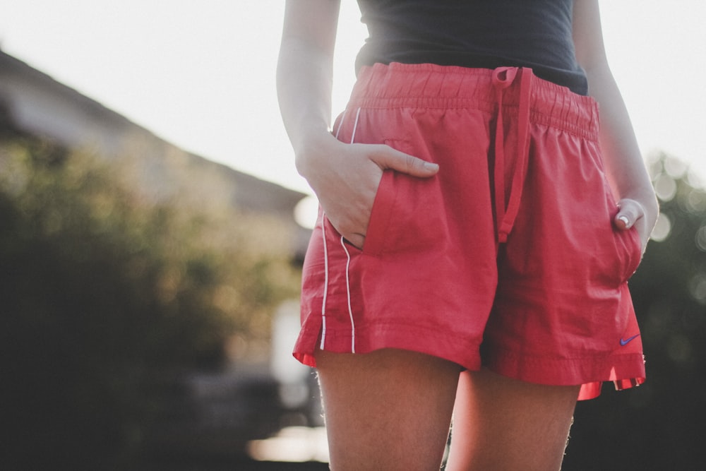 woman in black tank top and red shorts