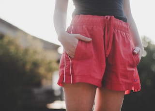 woman in black tank top and red shorts