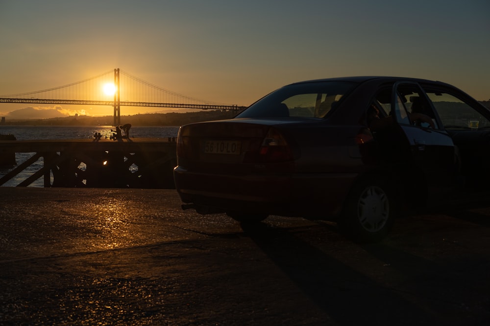 black car on road during sunset