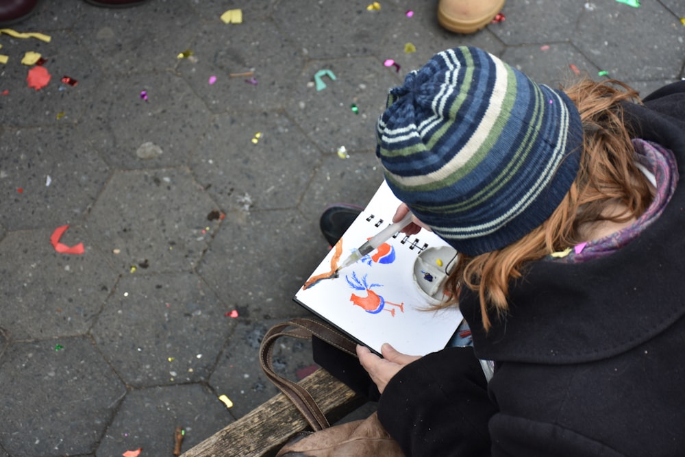 a person sitting on a bench with a book