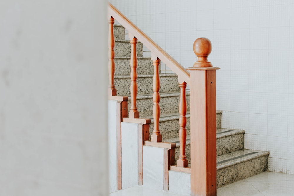 a set of stairs leading up to a white tiled wall