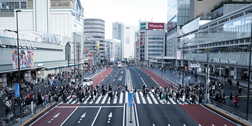 a group of people standing on the side of a road