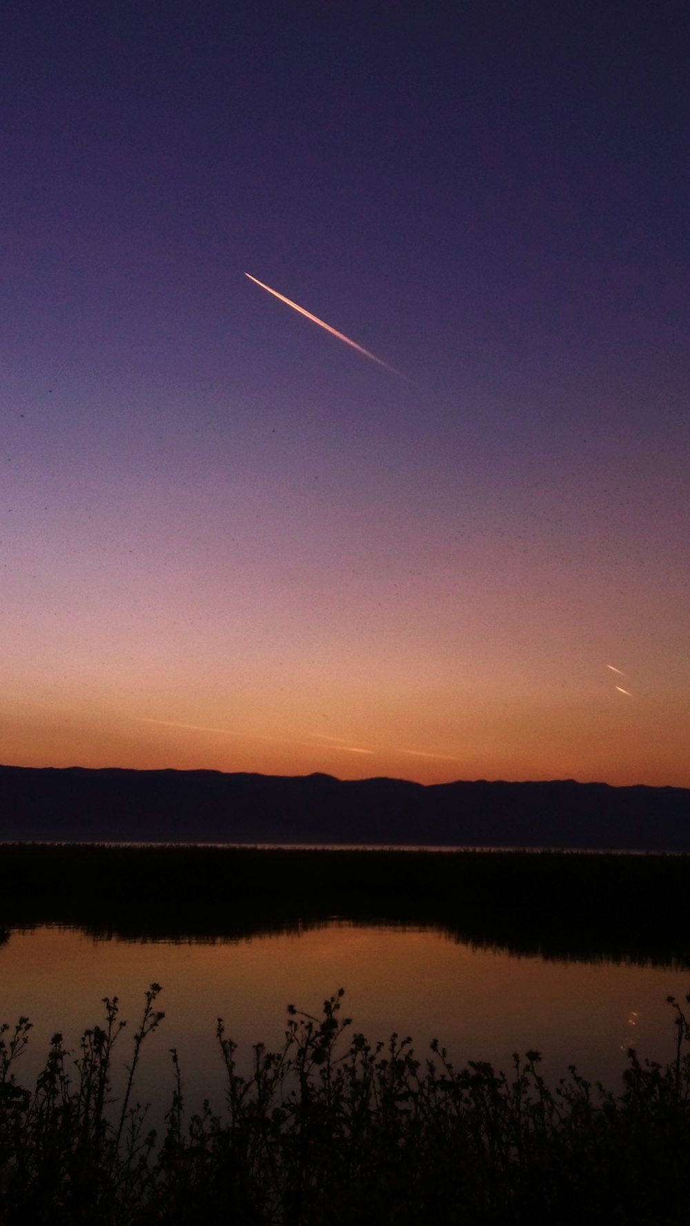 a plane is flying over a body of water