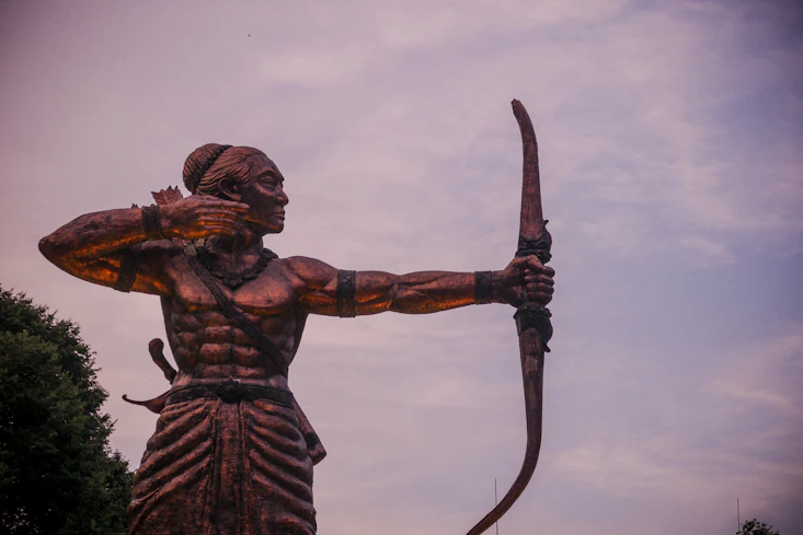 angel holding sword statue during daytime