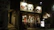 Smiling diners enjoying sushi and sake in a softly lit modern Japanese restaurant interior.