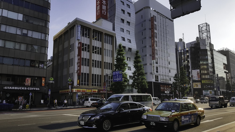 black sedan on road near high rise building during daytime