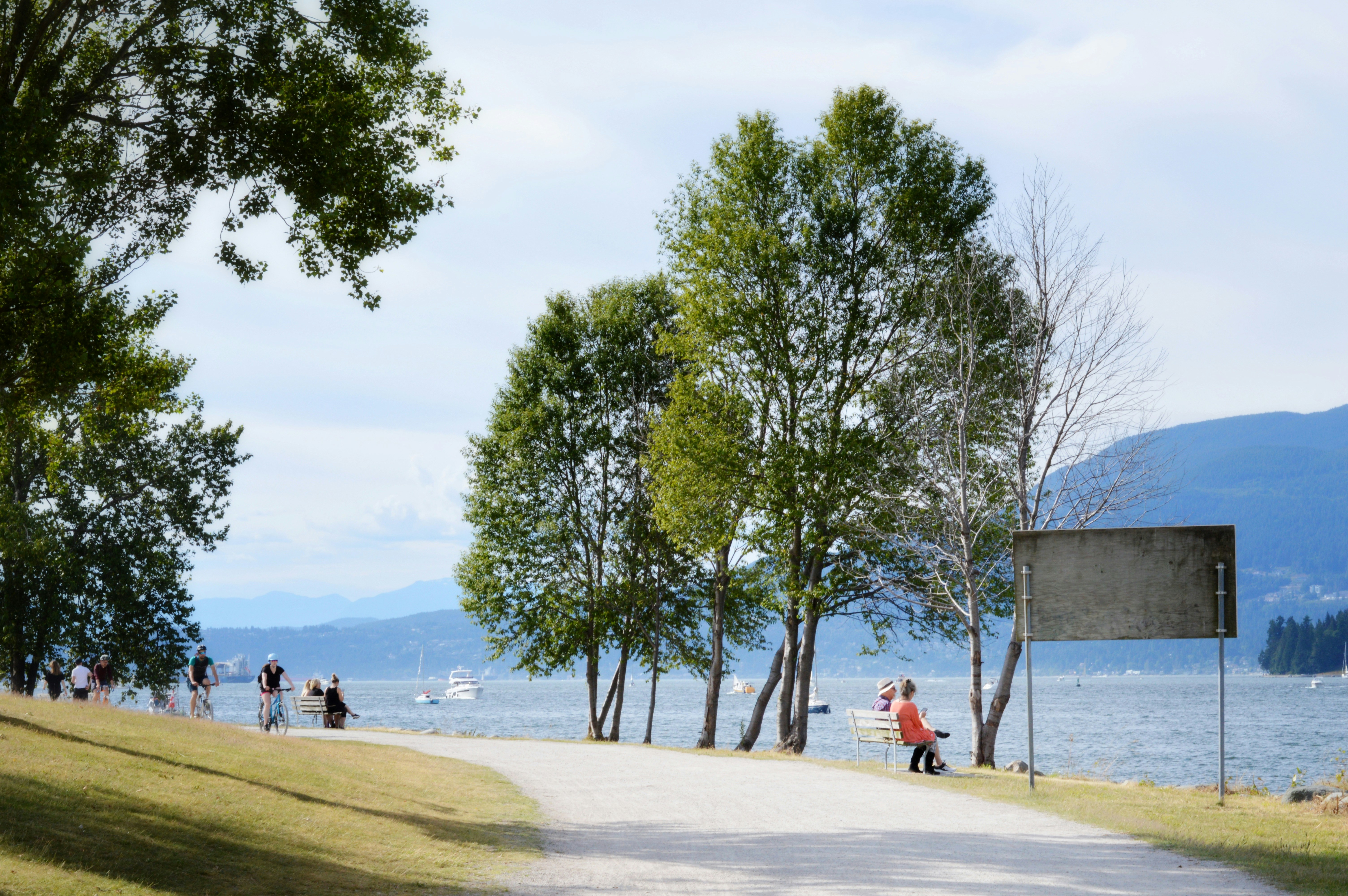 people walking on beach during daytime, Pedestrians in Stanley Park, Vancouver, Canada