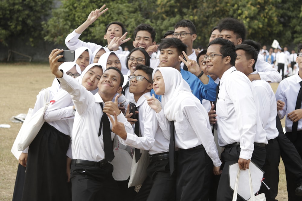 group of people wearing white dress shirts and black pants