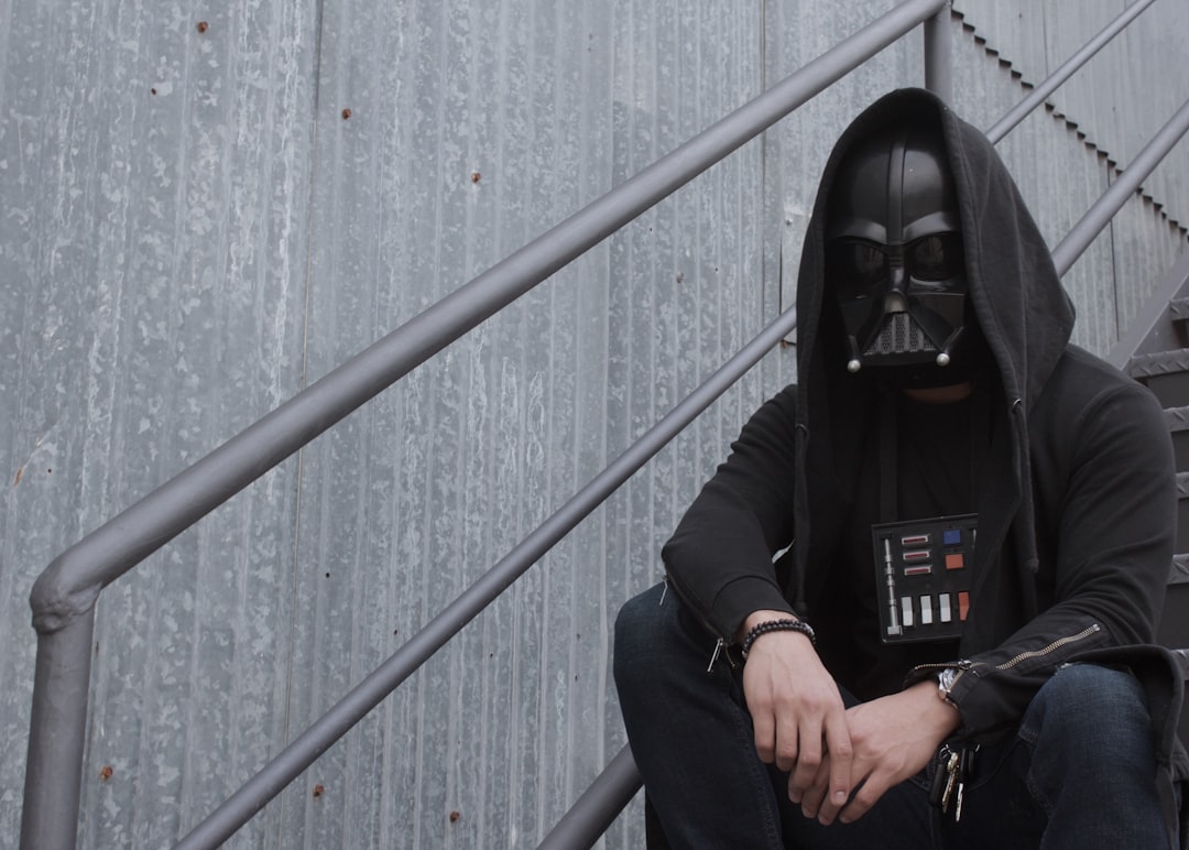 person in black leather jacket and black mask,