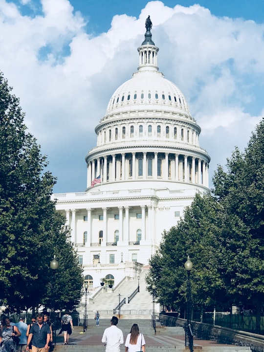 white concrete building under blue sky during daytime in US Capitol Grounds United States