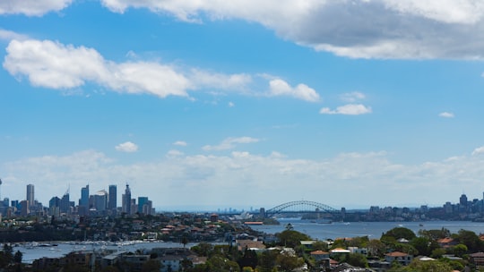 city skyline under blue sky and white clouds during daytime in Bondi Australia
