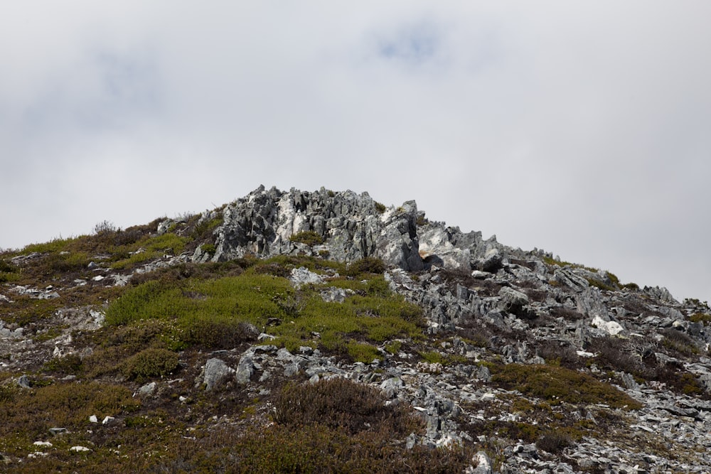 gray rocky mountain under white cloudy sky during daytime