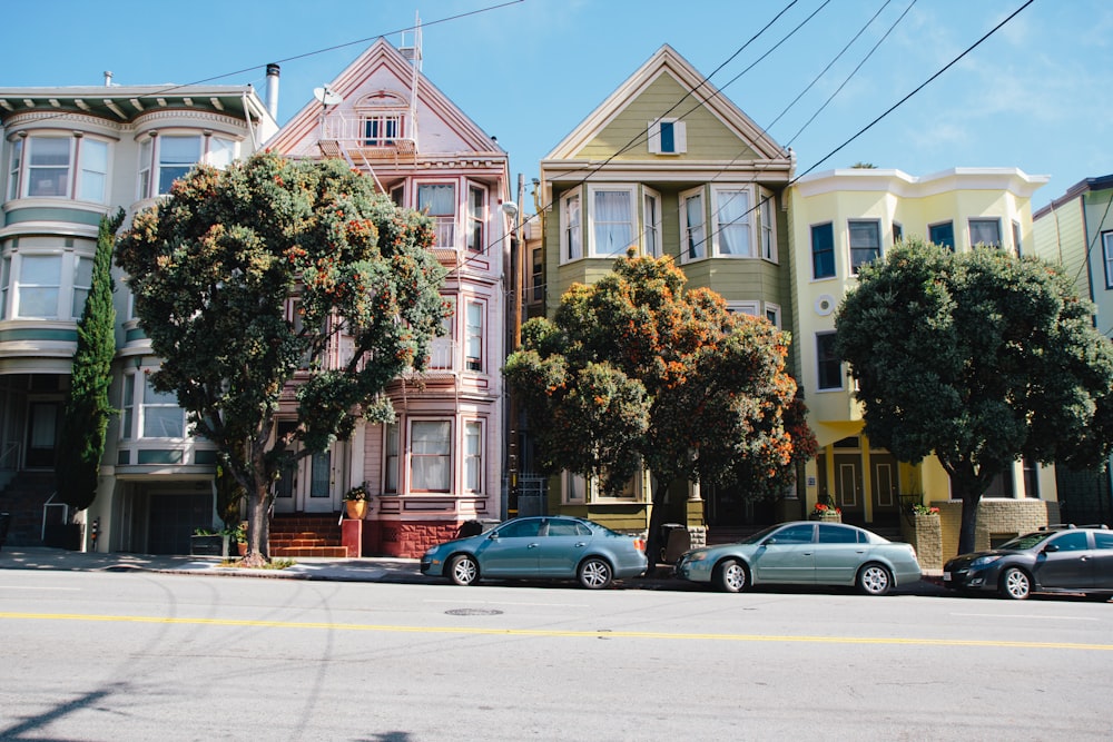 black sedan parked beside brown concrete building during daytime