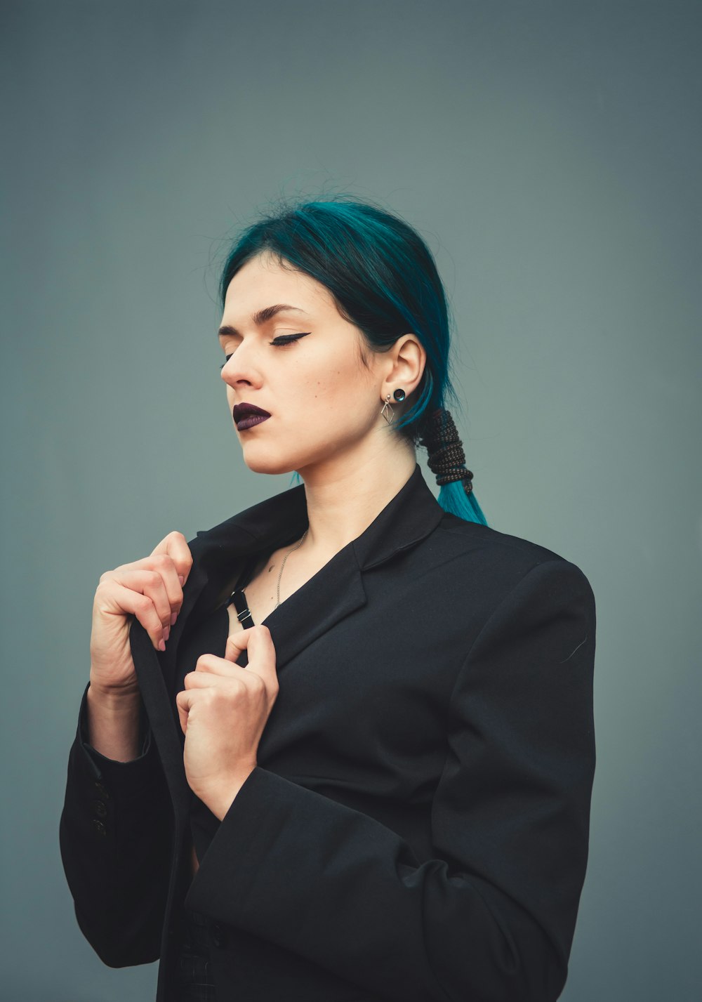 woman in black blazer holding microphone