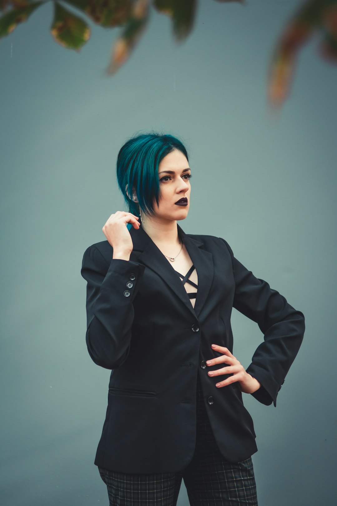 woman in black blazer holding her hair