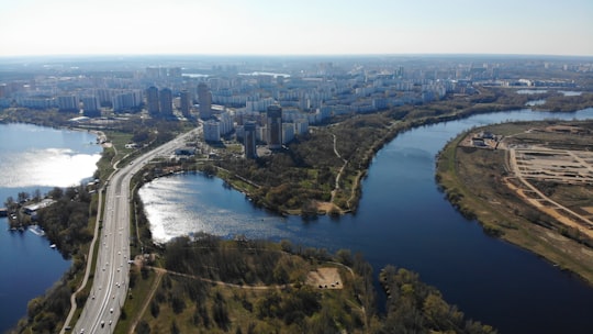 aerial view of city buildings and river during daytime in Strogino District Russia