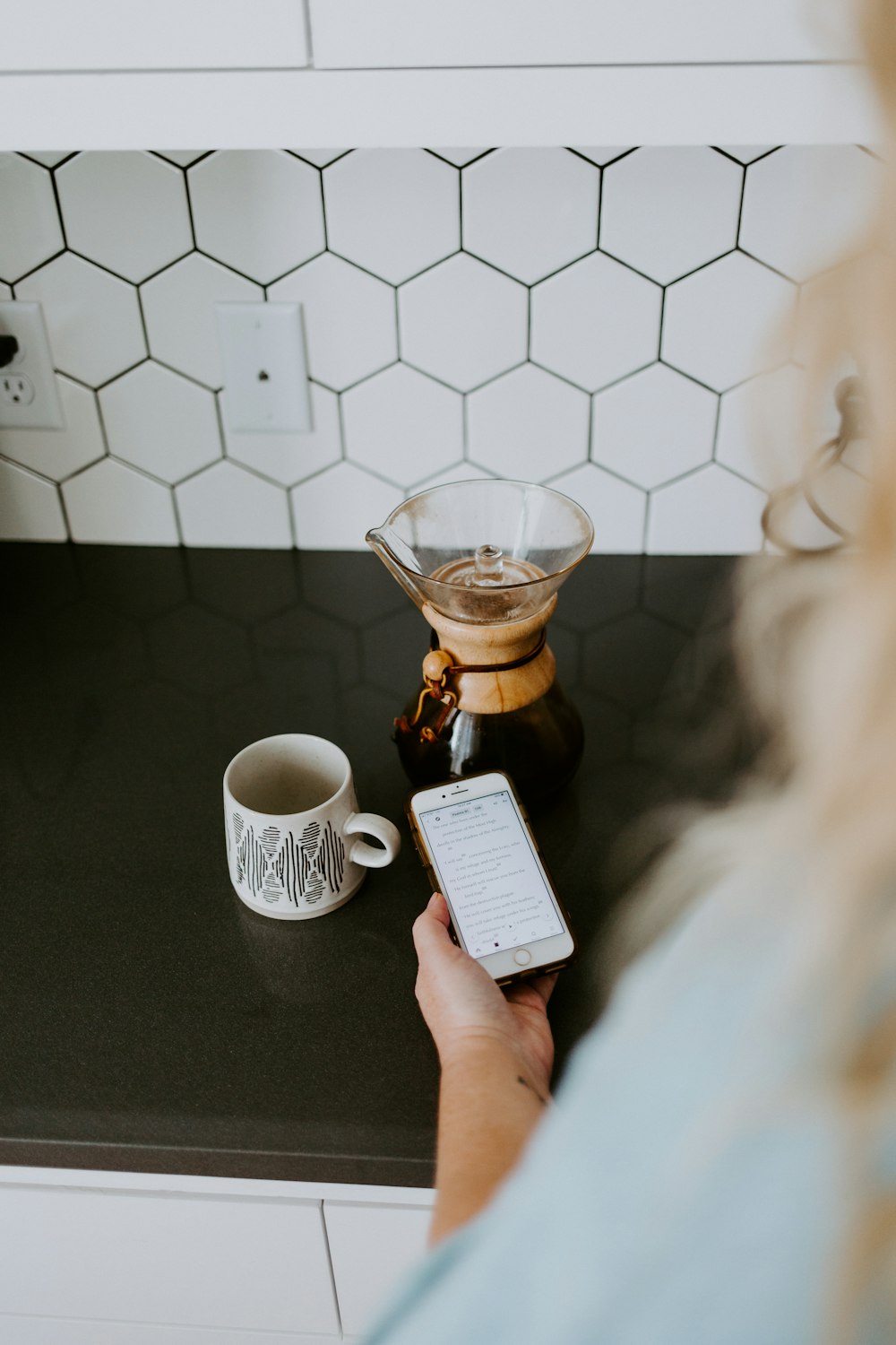 person holding white and brown ceramic mug