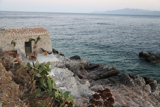 brown concrete house near body of water during daytime in Monemvasia Greece