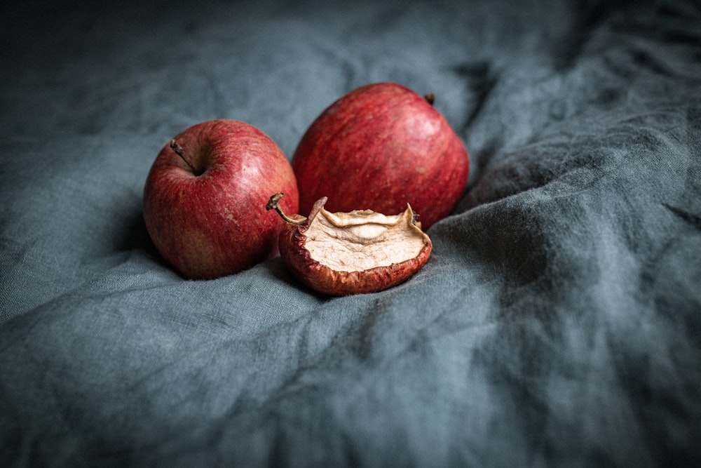 red apple fruit on gray textile
