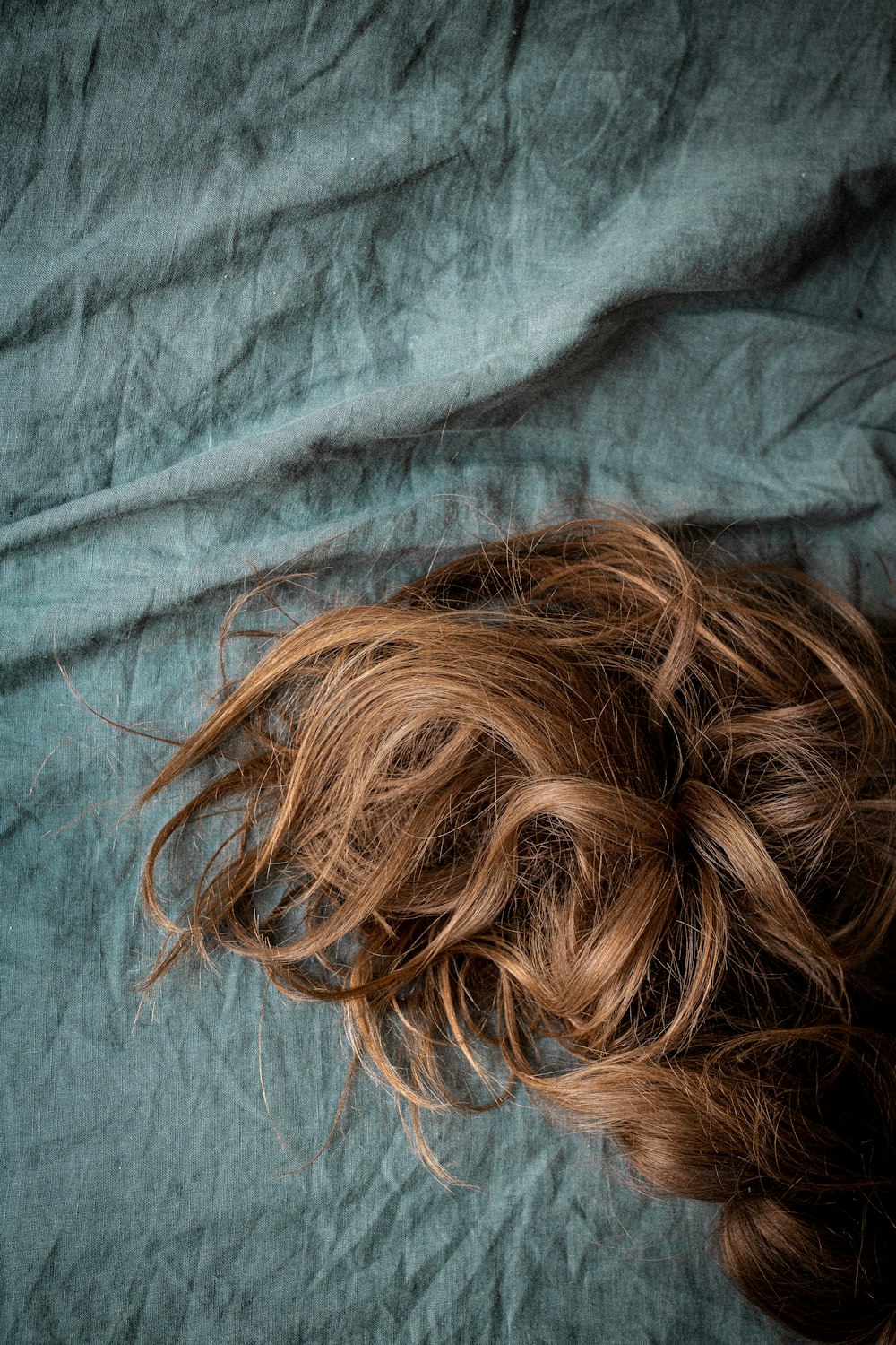 brown hair on blue textile