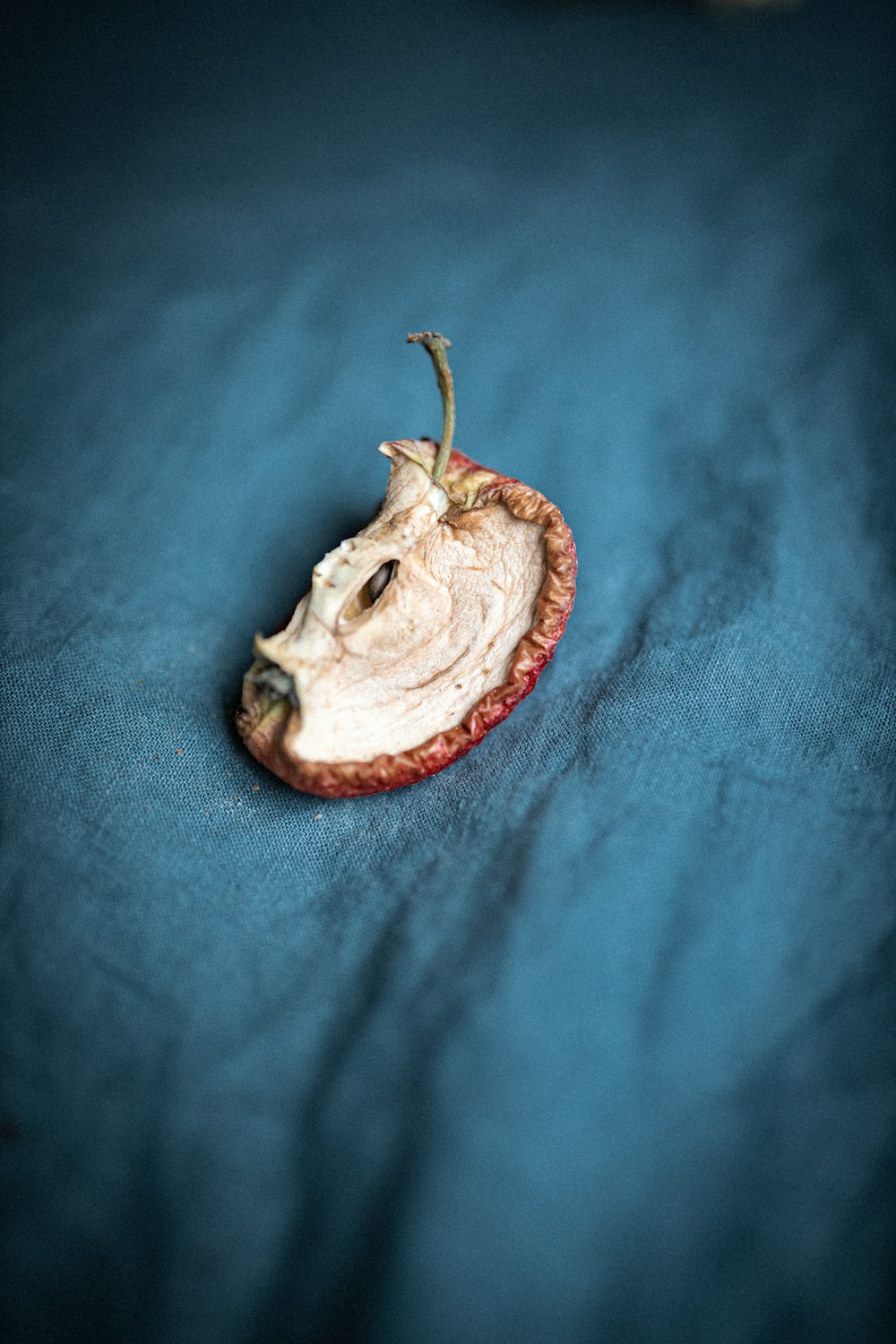 white and brown round fruit on blue textile