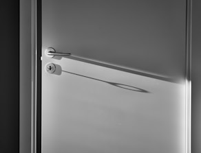 white wooden door with silver door lever