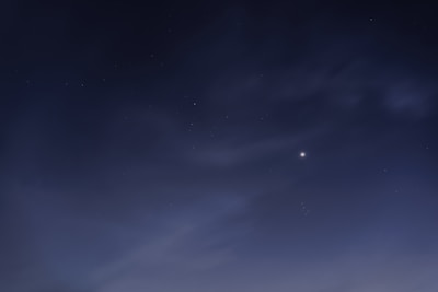 A serene night sky with a glowing red giant star illuminating a peaceful meditation scene.