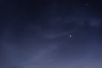 A serene night sky with stars aligned, highlighting a golden zodiac constellation glowing softly.