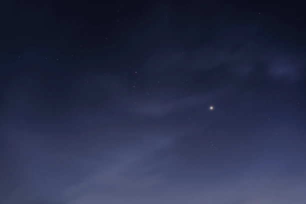 A serene image of a glowing star shining in a dark blue sky symbolizing hope.