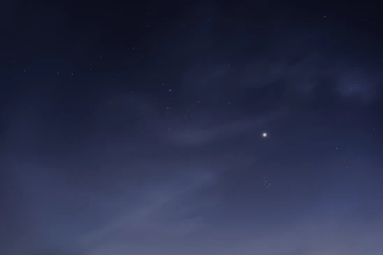 A serene night sky with stars aligned, highlighting a golden zodiac constellation glowing softly.
