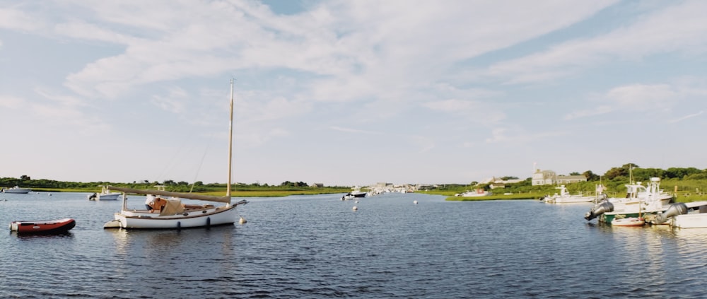 white boat on sea under cloudy sky during daytime