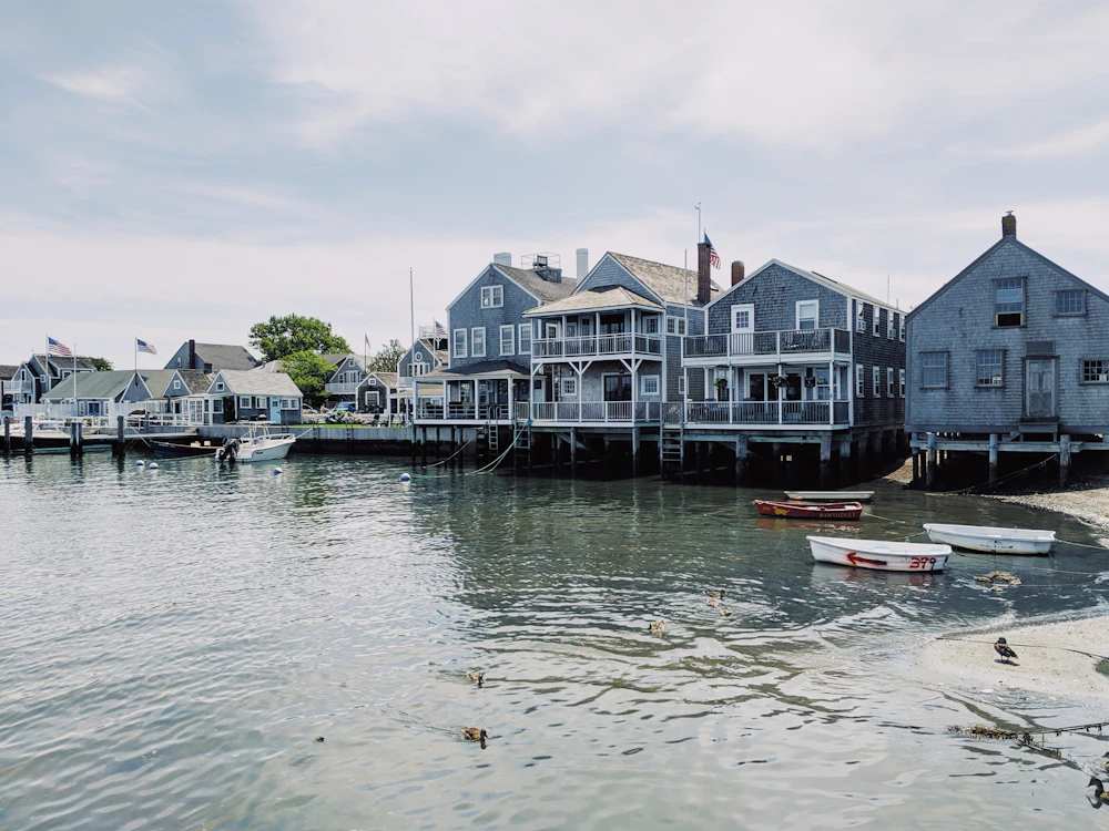 A harbour of grey-shingled houses and moored boats