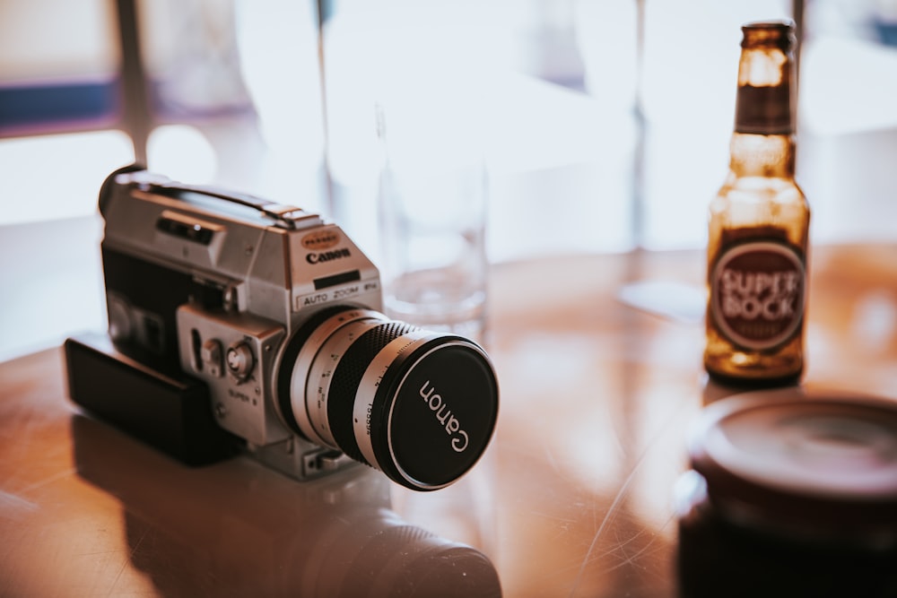 black and silver camera on brown wooden table