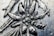 A close-up view of an intricate metal engraving depicting a floral pattern with detailed textures. The image highlights the craftsmanship involved in creating the piece.