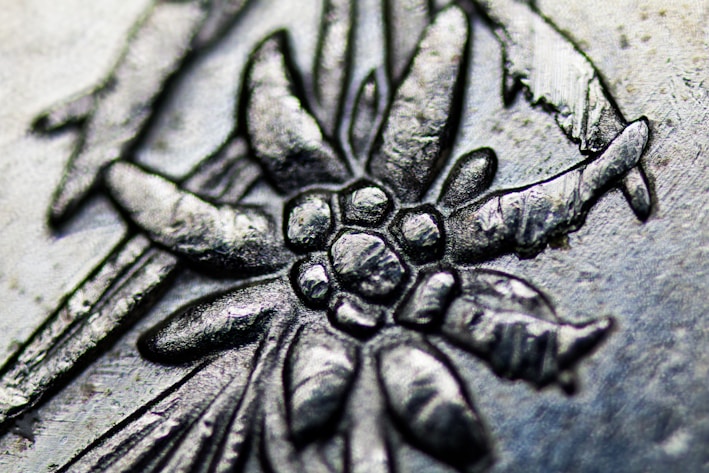Close-up of a finely engraved silver bracelet with delicate floral patterns.