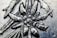 A close-up view of an intricate metal engraving depicting a floral pattern with detailed textures. The image highlights the craftsmanship involved in creating the piece.