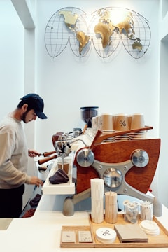 A barista using a robotic coffee system in a modern café.