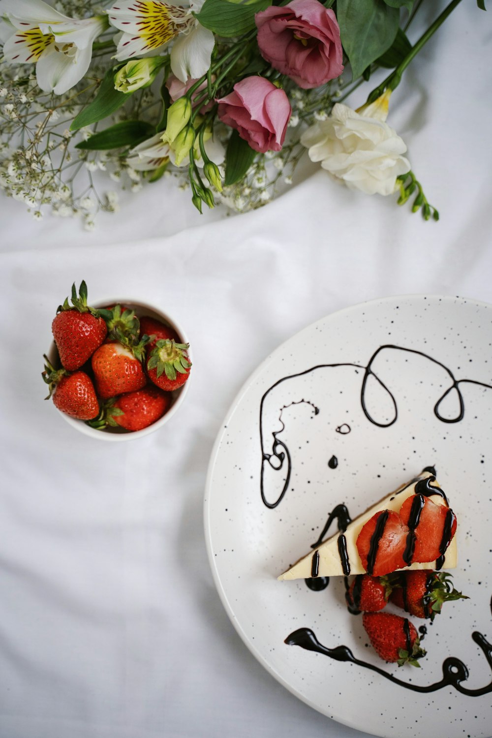 strawberry and blackberry on white ceramic plate