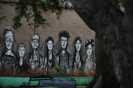 A colourful mural painted by local artists depicting faces and names of those remembered.