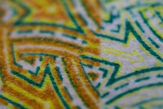 A close-up of a hand-painted fabric design with artistic patterns.