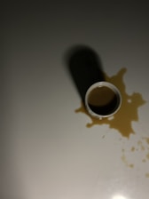 black and white ceramic mug on white table