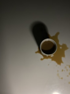 black and white ceramic mug on white table